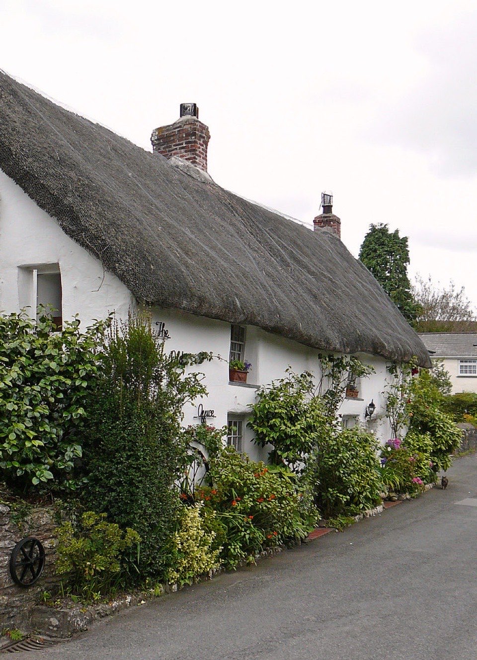 A white rendered cottage under thatch at Feock in Cornwall